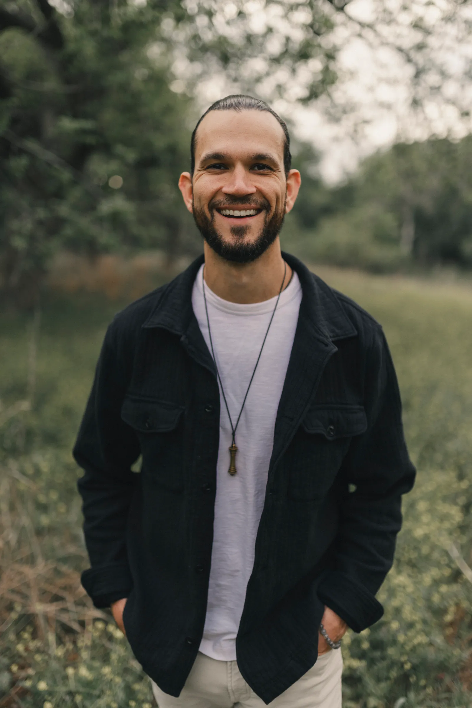 Austin standing in a field, smiling